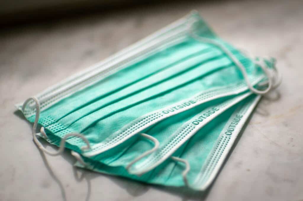 Three surgical masks fanned out